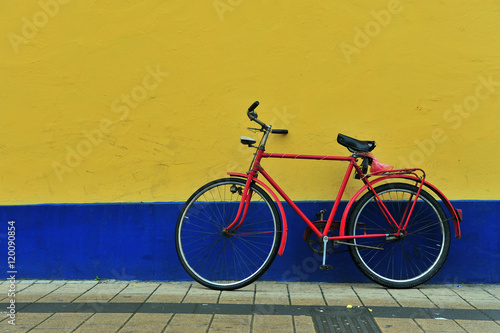 Old bike at the painted wall photo