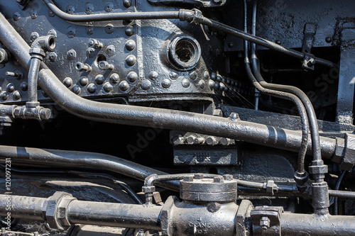 Detail of steam train engine; the strength and power of metal, engineering, coal and manpower for transporting passengers and goods across the USA.