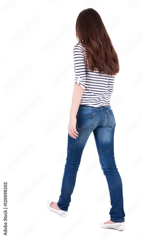 back view of walking woman in jeans . beautiful brunette girl in motion. backside view of person. Rear view people collection. Isolated over white background. The girl in a striped T-shirt with back view of walking woman in jeans . beautiful brunette girl in motion. backside view of person. Rear view people collection. Isolated over white background. The girl in a striped T-shirt with