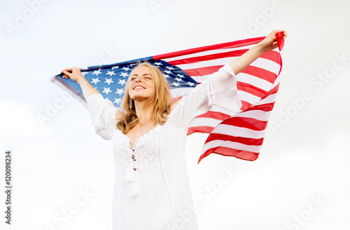 happy young woman with american flag outdoors photo