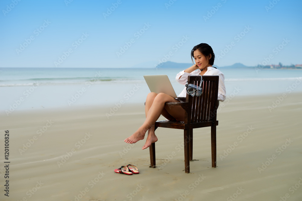Working with laptop at beach