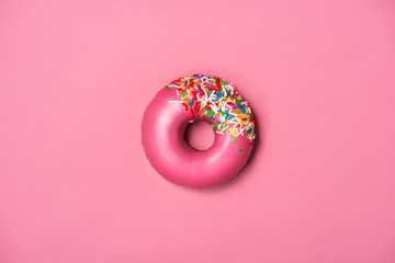 Donuts with icing on pastel pink background. Sweet donuts.