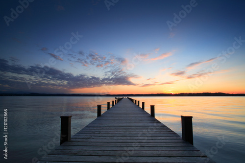 Fototapeta Naklejka Na Ścianę i Meble -  Lake at Sunset, Long Wooden Pier