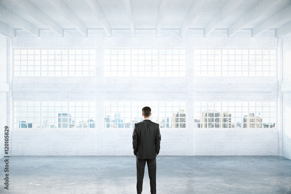 Obraz premium Man standing in empty hangar