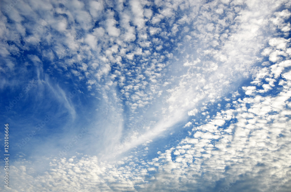 Fluffy and wispy white cirrus clouds in a deep blue summer sky Fluffy and wispy white cirrus clouds in a deep blue summer sky