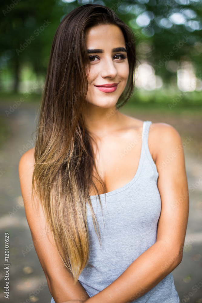 Outdoors portrait in park of a beautiful tanned teen student girl. Outdoors portrait in park of a beautiful tanned teen student girl.
