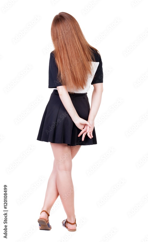 Back view of young redhead woman pointing at wall. beautiful girl in dress. Rear view people collection. backside view of person. Isolated over white background. Back view of young redhead woman pointing at wall. beautiful girl in dress. Rear view people collection. backside view of person. Isolated over white background.