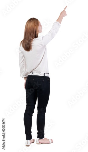 Back view of pointing woman. beautiful blonde girl. Rear view people collection. backside view of person. Isolated over white background.