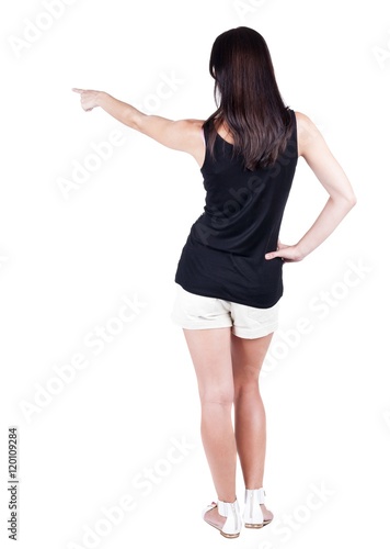 Back view of  pointing woman. beautiful brunette  girl in shorts. Rear view people collection.  backside view of person.  Isolated over white background. © ghoststone