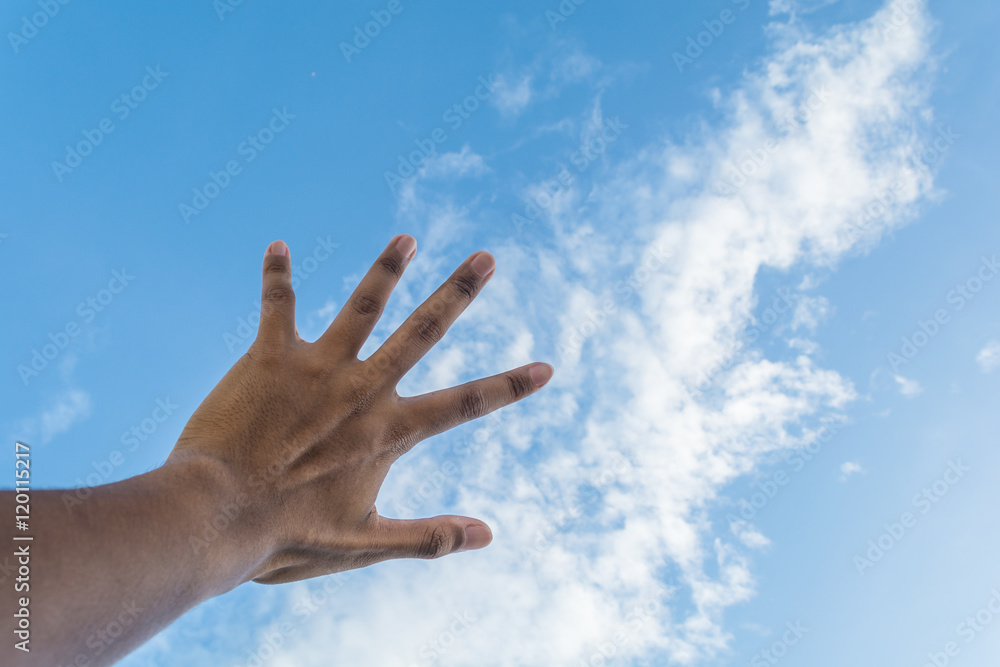 Asian man's hand reaching blue sky and white cloud. Asian man's hand reaching blue sky and white cloud.