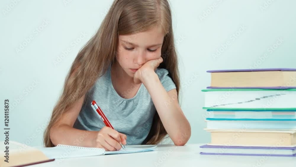 Girl something writing in her notebook. Isolated on white Girl something writing in her notebook. Isolated on white