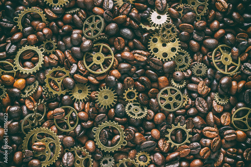 mock up for background in steampunk style. Roasted coffee beans mixed with brass gears. Grunge style toned. Top view.