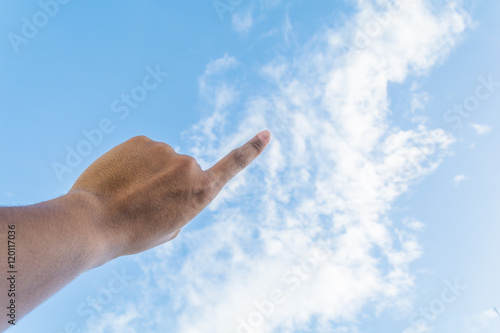 Asian man's index finger points to the bright blue sky with whit