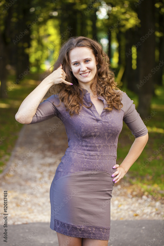Beautiful woman making a call me gesture Beautiful woman making a call me gesture