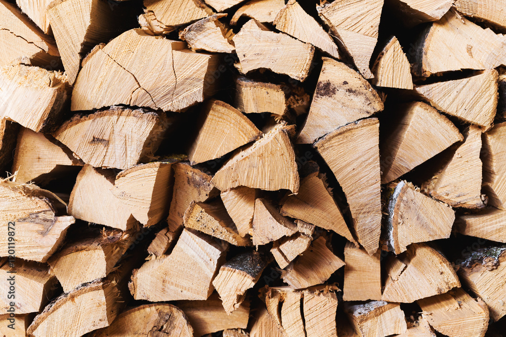 Chopped brown firewood, stacked and ready for winter Chopped brown firewood, stacked and ready for winter