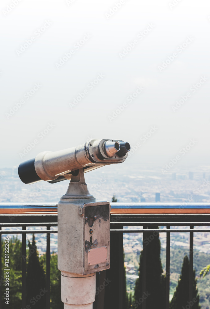 Touristic telescope look at the city view of Barcelona, close up old metal binoculars background overlooking the mountain, hipster coin operated in panorama observation nature blue sky, mockup flare Touristic telescope look at the city view of Barcelona, close up old metal binoculars background overlooking the mountain, hipster coin operated in panorama observation nature blue sky, mockup flare