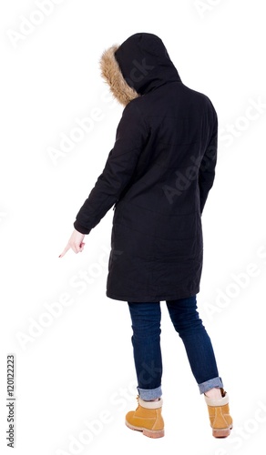 Back view of  pointing young women in parka. Young girl gesture. Rear view people collection.  backside view of person.  Isolated over white background.  © ghoststone