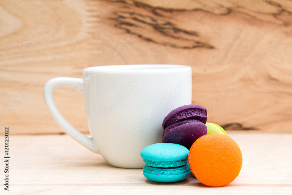 Colorful macaroons in stack on light wooden background Colorful macaroons in stack on light wooden background
