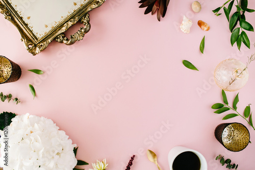 creative decorated and arranged flat lay frame concept with vintage tray, hydrangea, shells, coffee, golden spoon, branches on pink background. top view