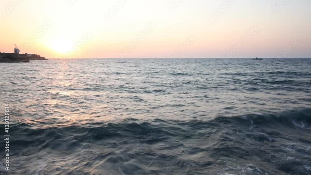 Beautiful sunset over the sea. Sailing boat on the waves Beautiful sunset over the sea. Sailing boat on the waves
