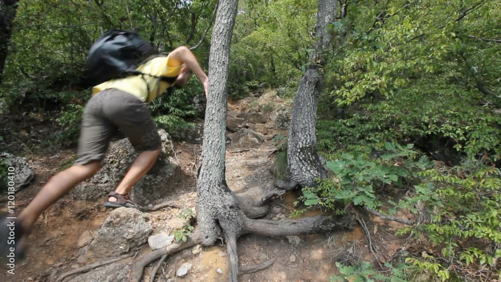 young boy climbing over rocks young boy climbing over rocks