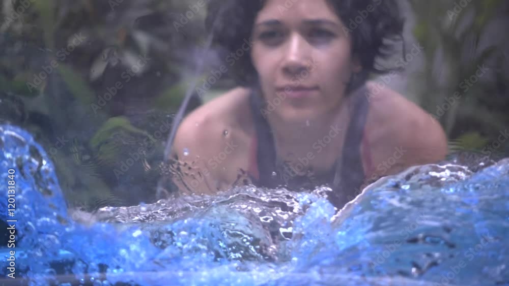 Hispanic woman observing science project, recipient filled with water spinning demonstrating the centrifuge force. Liquid experiment. Slow motion Hispanic woman observing science project, recipient filled with water spinning demonstrating the centrifuge force. Liquid experiment. Slow motion