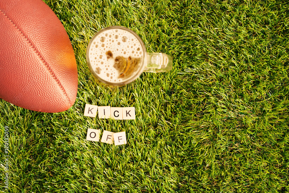 Φωτογραφία Vintage football and beer jar over grass with Kick Off message in wood tiles