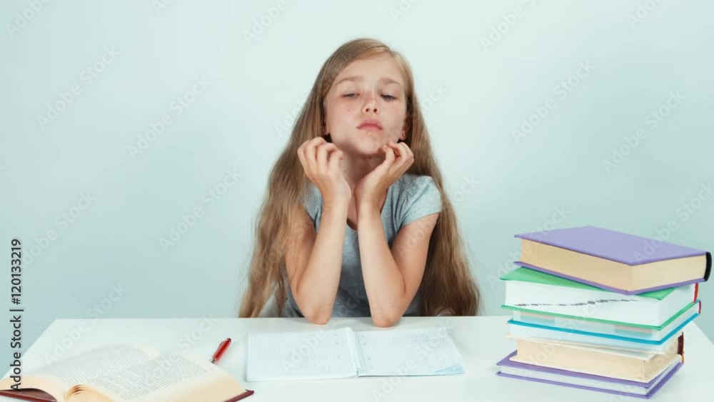 Portrait sad schoolgirl looking at camera on white background Portrait sad schoolgirl looking at camera on white background
