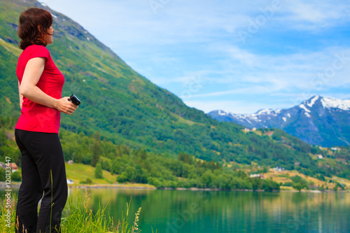 Tourist woman enjoying fjord view in Norway