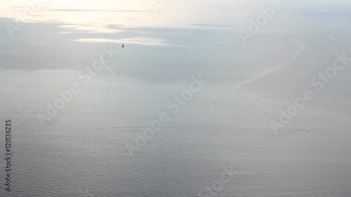 sunset sky reflected in the sea. sail boats