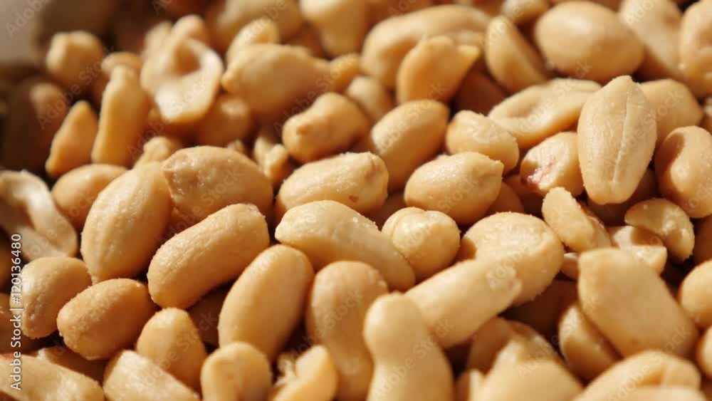 Bowl full of groundnut snack food slow tilting background 4K 2160p UltraHD video - Salted and roasted snack Arachis hypogaea peanuts pile 4K 3840X2160 UHD tilt footage Bowl full of groundnut snack food slow tilting background 4K 2160p UltraHD video - Salted and roasted snack Arachis hypogaea peanuts pile 4K 3840X2160 UHD tilt footage