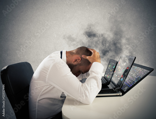 Fotografie Businessman overworked worn computers