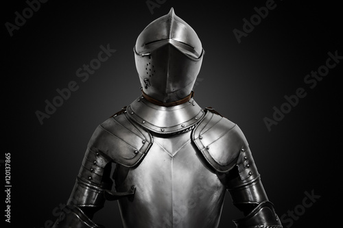 Fototapeta Old metal knight armour on black background