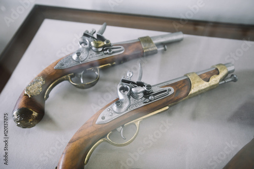 Old vintage wooden guns on a showercase