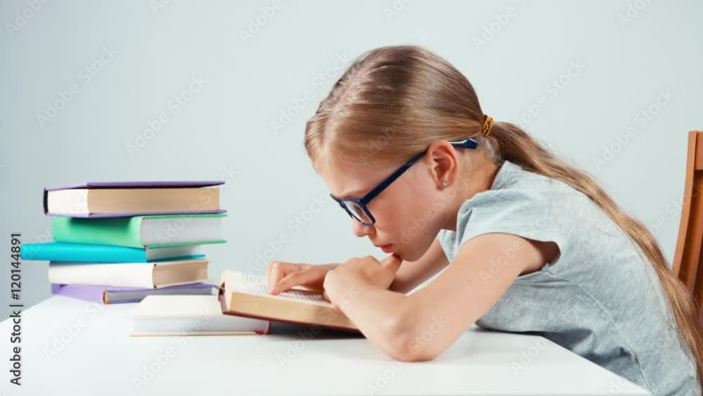 Portrait profile child girl 7-8 years old reading book and throws up hands. Isolated on white Portrait profile child girl 7-8 years old reading book and throws up hands. Isolated on white