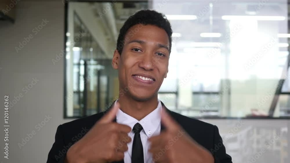 Thumbs Up by Black Businessman in Suit in Office Thumbs Up by Black Businessman in Suit in Office