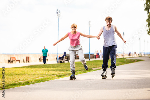 Active young people friends rollerskating outdoor. © anetlanda