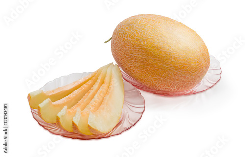 Several slices and whole of melon on pink glass dishes