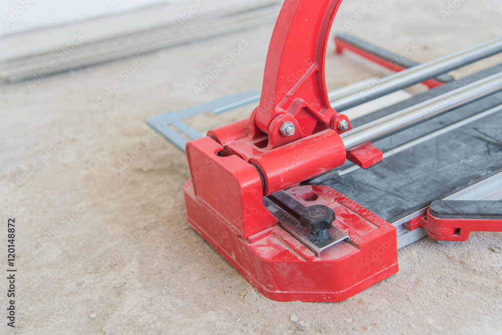 Industrial tiler builder worker working with floor tile cutting equipment at repair renovation work,Worker working on laying of porcelain tiles Industrial tiler builder worker working with floor tile cutting equipment at repair renovation work,Worker working on laying of porcelain tiles