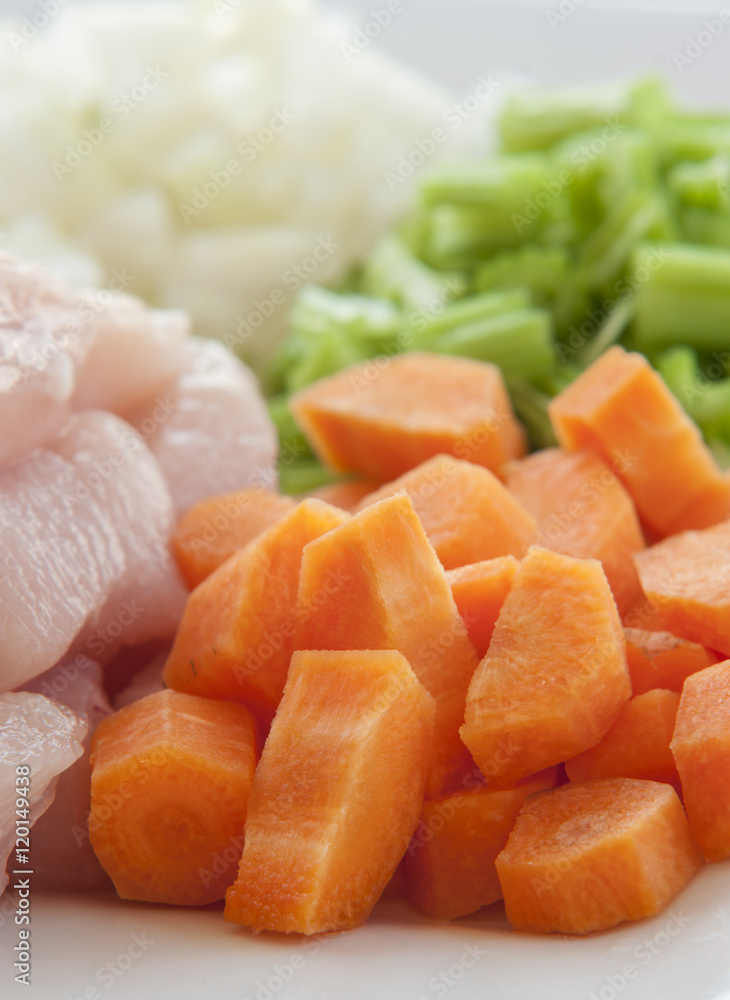 Heap of small piece raw chicken with vegetables Heap of small piece raw chicken with vegetables