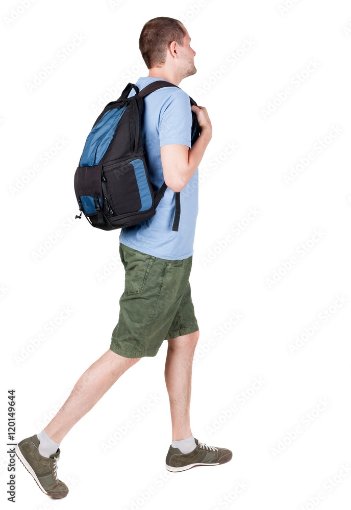 back view of walking  man  with backpack.  brunette guy in motion. backside view of person.  Rear view people collection. Isolated over white background. young man goes to side of a rolling travel bag