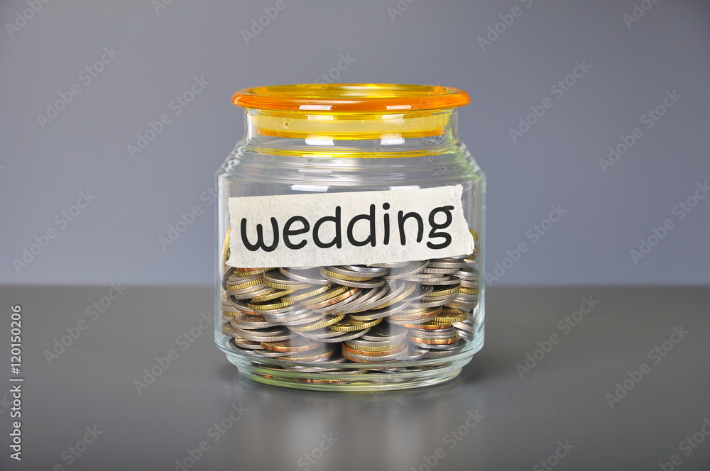Saving concept of coins in the glass jar for wedding purpose Saving concept of coins in the glass jar for wedding purpose