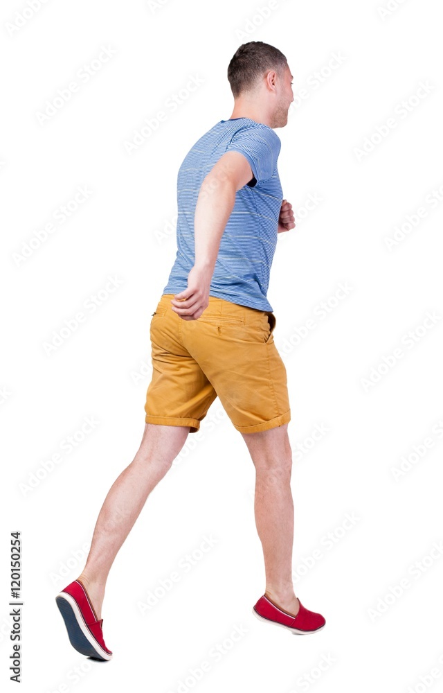 Back view of running man in t-shirt and shorts. Walking guy in motion. Rear view people collection. Backside view of person. Isolated over white background. Back view of running man in t-shirt and shorts. Walking guy in motion. Rear view people collection. Backside view of person. Isolated over white background.