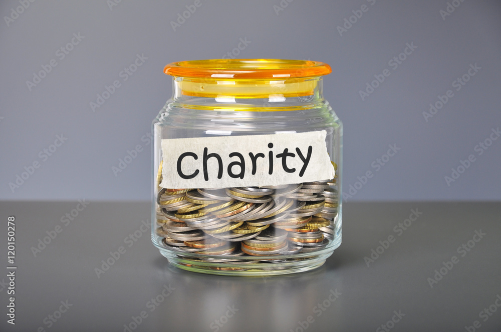 Saving concept of coins in the glass jar for charity purpose Saving concept of coins in the glass jar for charity purpose