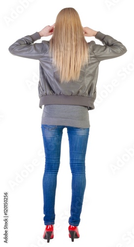 back view of  beautiful blonde Young woman thinking.  girl in jacket, jeans and red kitten heels. Rear view people collection.  backside view of person.  Isolated over white background photo