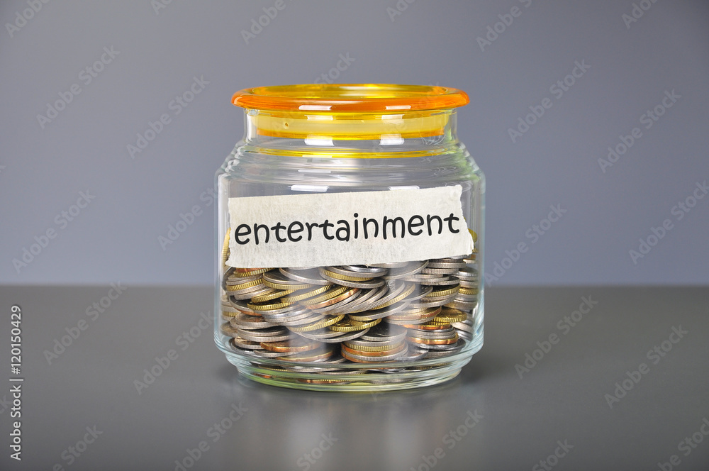 Saving concept of coins in the glass jar for entertainment purp Saving concept of coins in the glass jar for entertainment purp