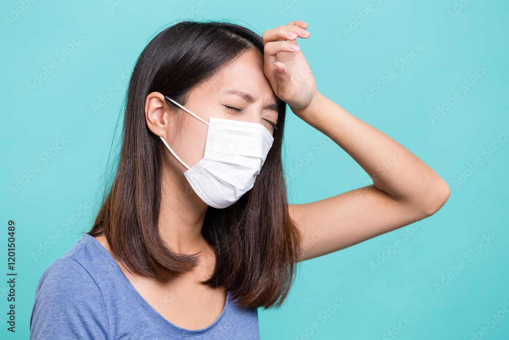 Woman wearing face mask and suffer from headache Woman wearing face mask and suffer from headache