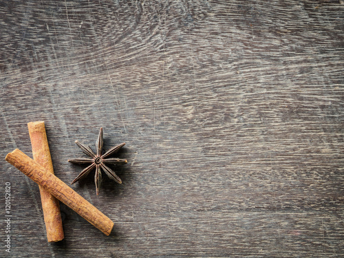 Top view of cinnamon and star anise on wooden background