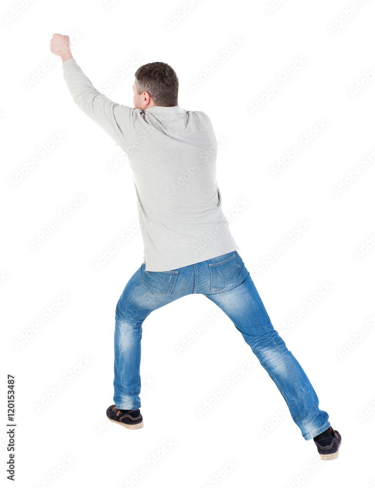 back view of standing man pulling a rope from the top or cling to something. guy watching. Rear view people collection.  backside view of person.  Isolated over white background.