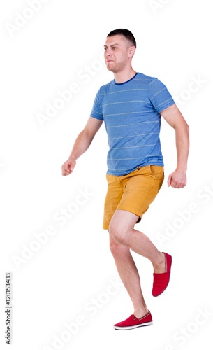Back view of running man in t-shirt and shorts. Walking guy in motion. Rear view people collection. Backside view of person. Isolated over white background.